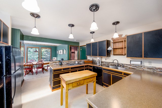 Kitchen with center island, pendant lighting and dining nook