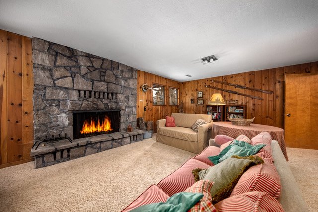 Cozy den with floor-to-ceiling stone fireplace