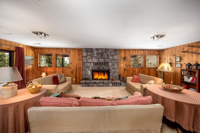 Lower-level family room with stone fireplace