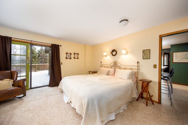 Primary bedroom with king bed and slider to the deck